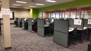 an array of grey cubicles in an office 