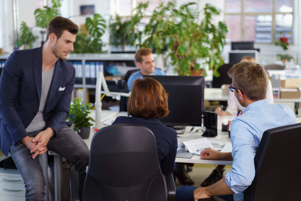 a group of young employees collaborating in a shared work space