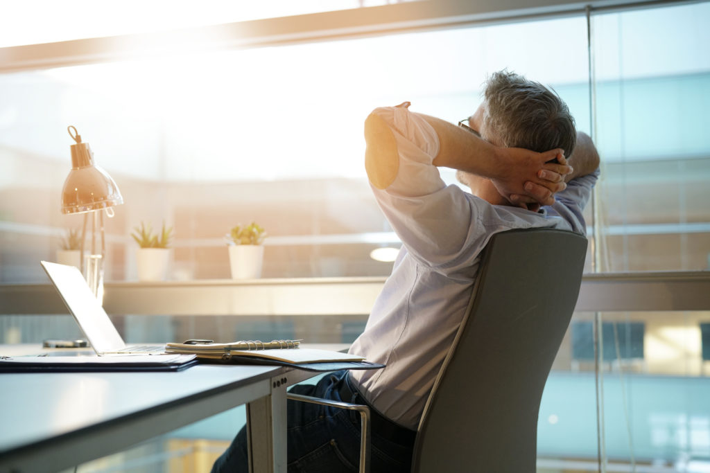 Businessman in office relaxing in chair