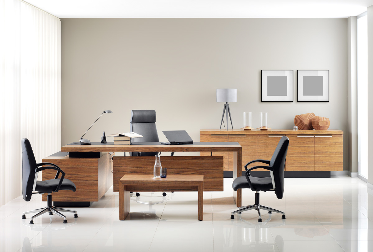 A modern office space with a wood desk and black chairs in El Paso.